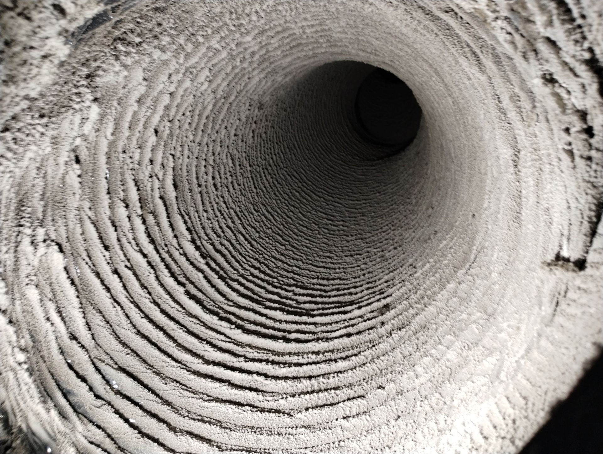 A black and white photo of the inside of a pipe