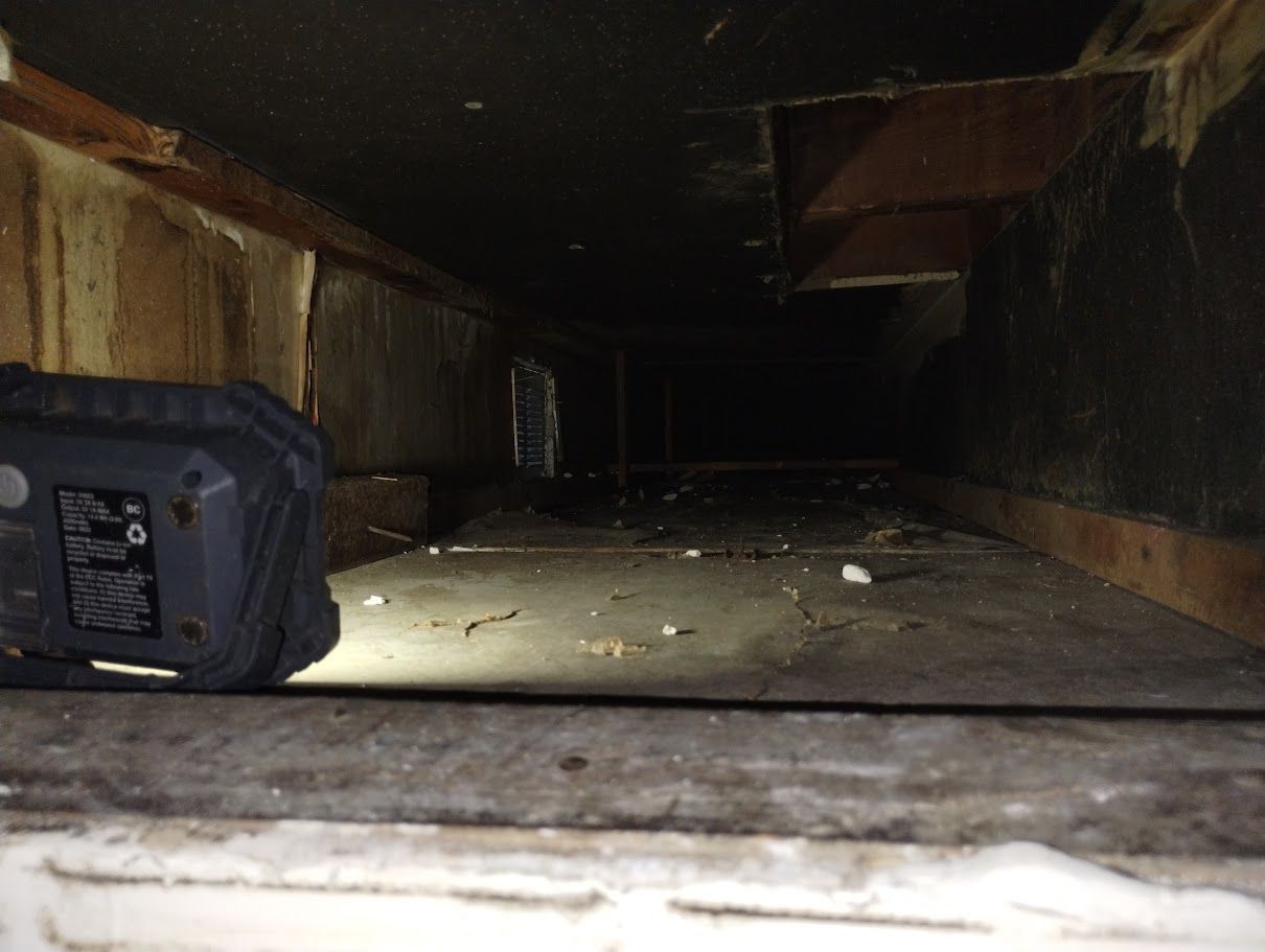 A flashlight is sitting in the corner of a dark room