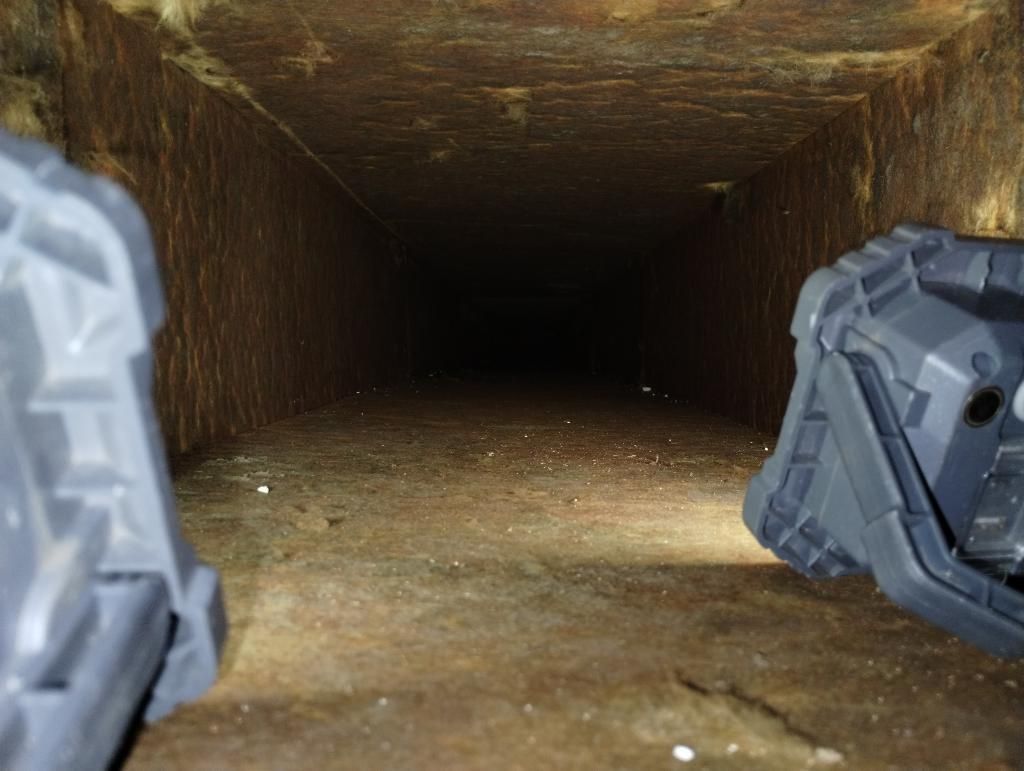 A person is standing in the middle of a dark tunnel