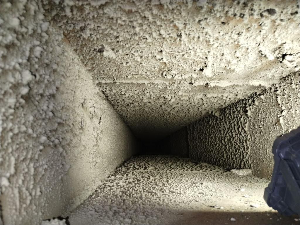 A person is standing in the middle of a very dirty room