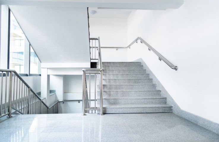 Empty hospital staircase with handrails and railing