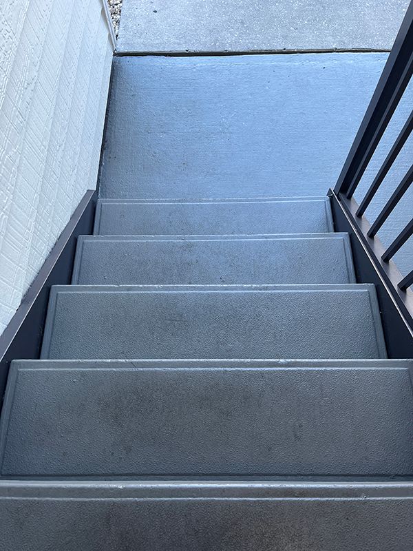 Durable concrete treads and chic metal stringers create a stylish staircase