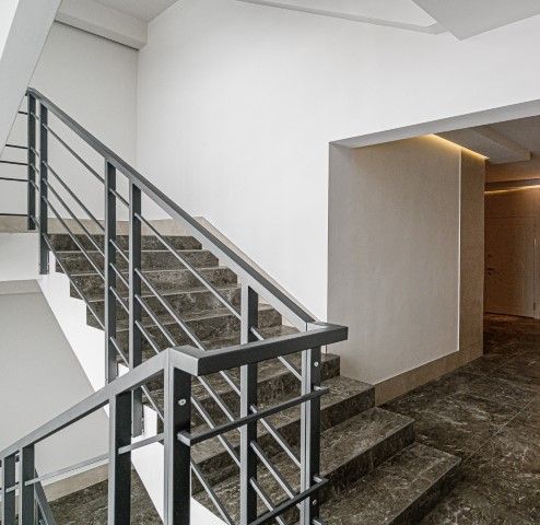 Elegant marble staircase inside a modern Fort Carson apartment.