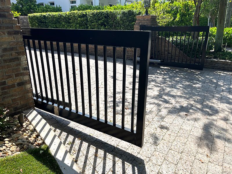 double door automatic gate, opening out over paver driveway