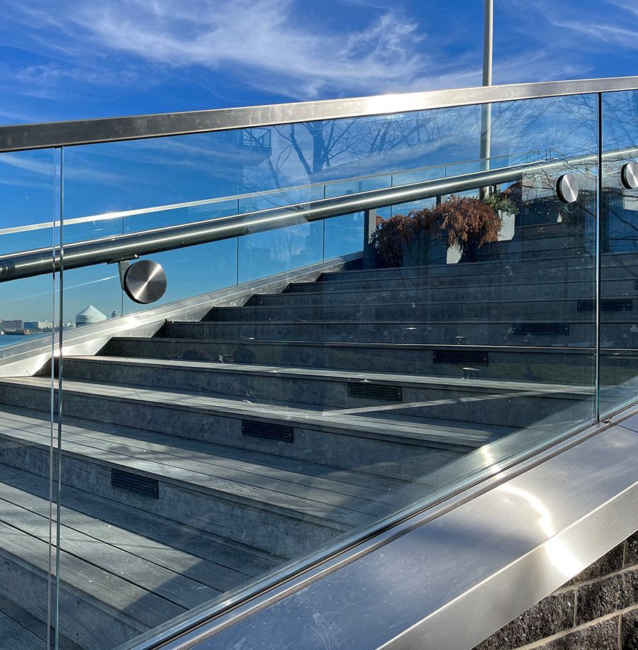 glass panels with metal frames along side public stairs