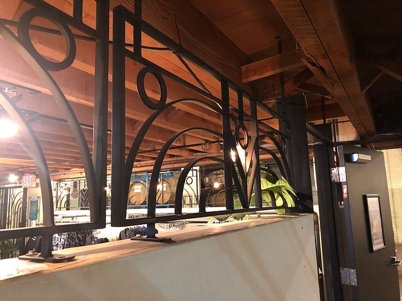 Custom-built iron dividers seamlessly match the restaurant's visual theme.