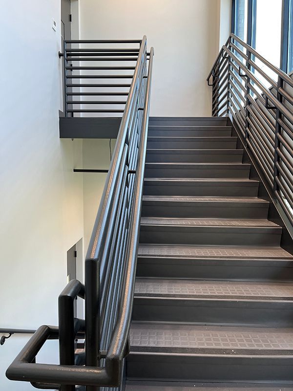 Modern metal-accented stairwell featuring interquest construction