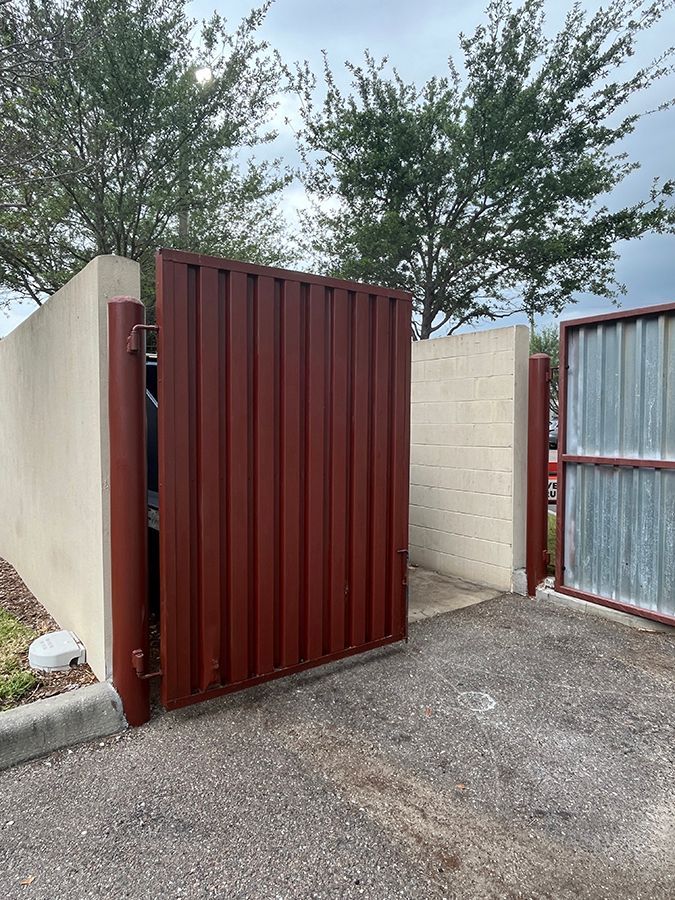 new dumpster gates behind restaurant to hold trash bins