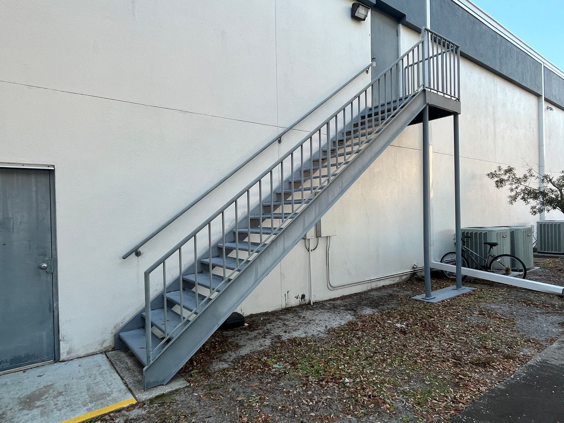 straight flight of steel stairs with landing for fire escape outside commercial building