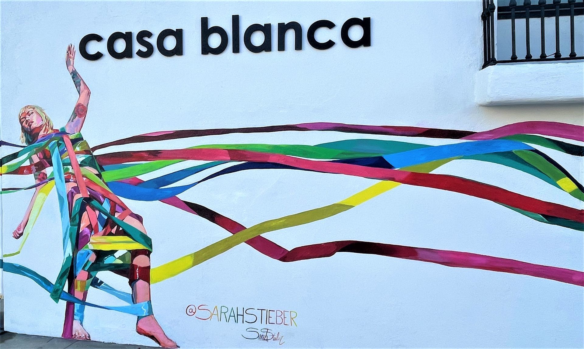 A mural on a white wall labeled 