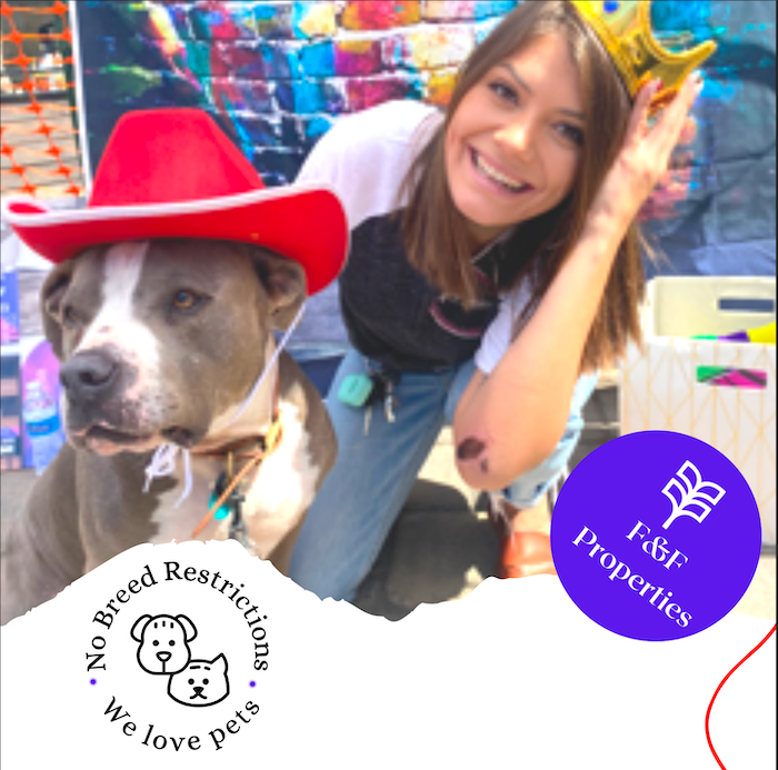 A smiling person wearing a gold crown poses with a dog wearing a red cowboy hat, promoting pet-friendly housing.