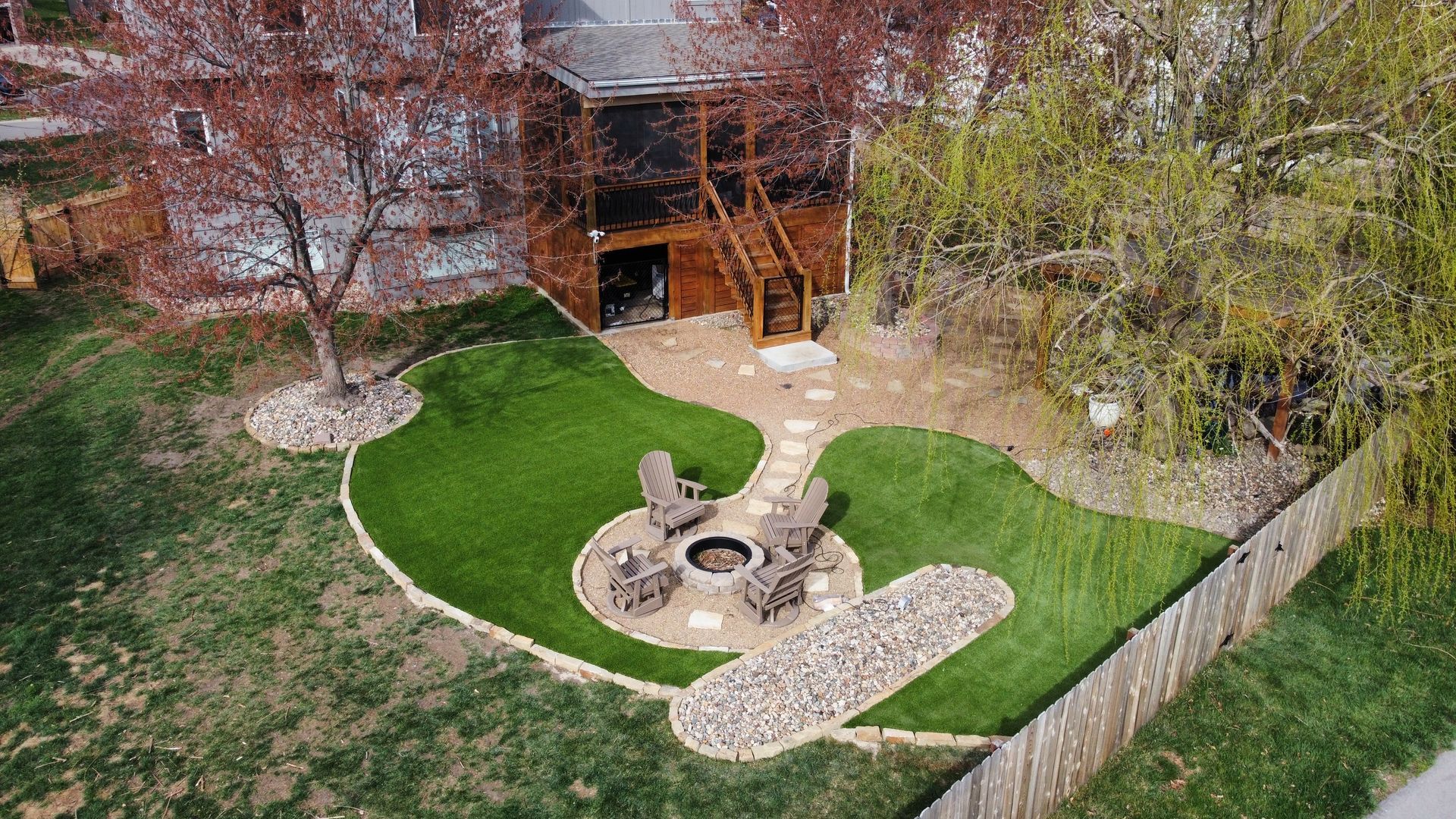 A large swimming pool is surrounded by an artificial lawn.