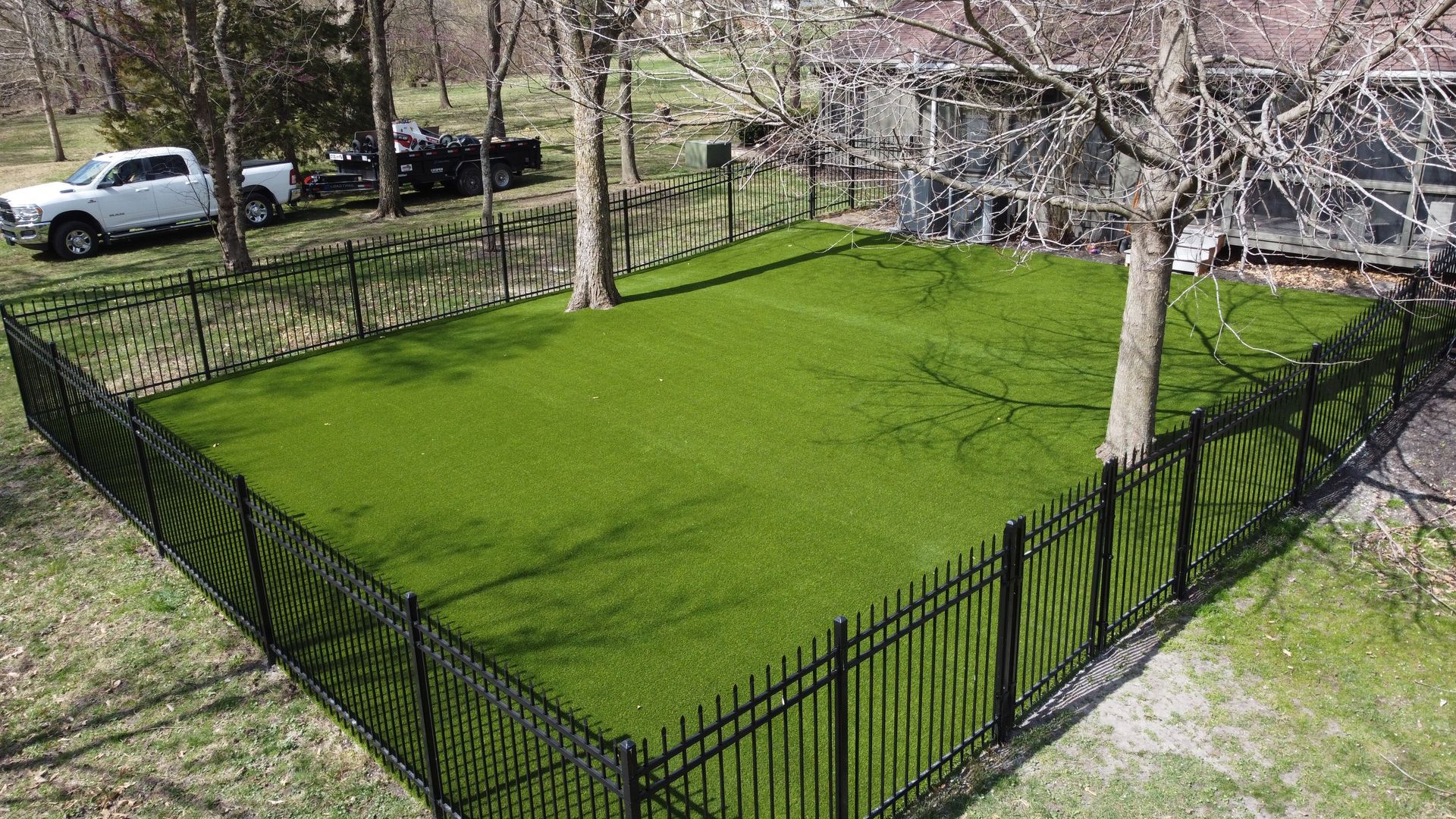 An aerial view of a backyard with a putting green and a pool.