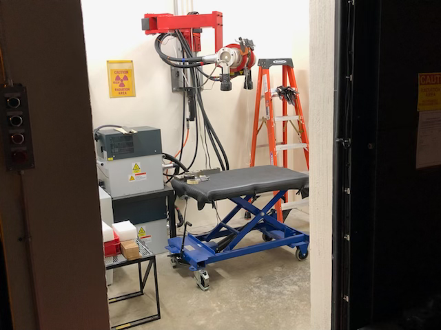 A room with a table and a ladder in it