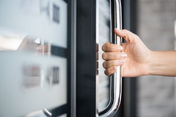 Woman holding the handle of the sliding door