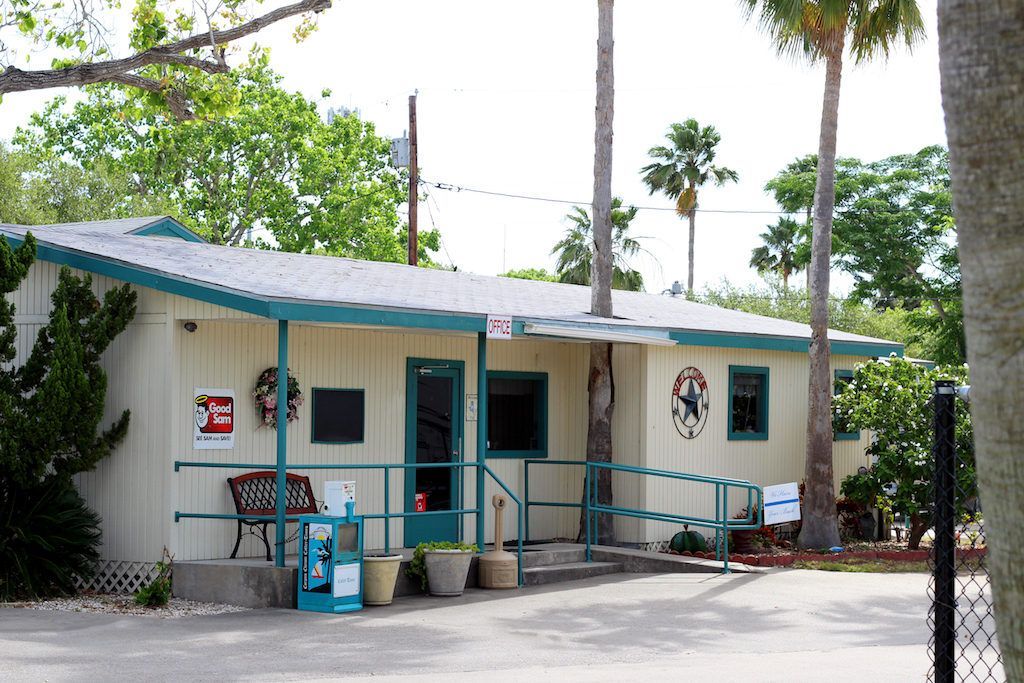A white house with a blue porch and a sign that says ' ambulance ' on it