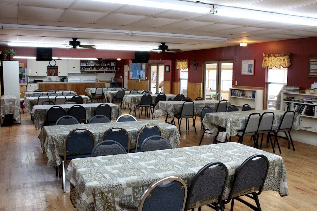 A large room with tables and chairs in it