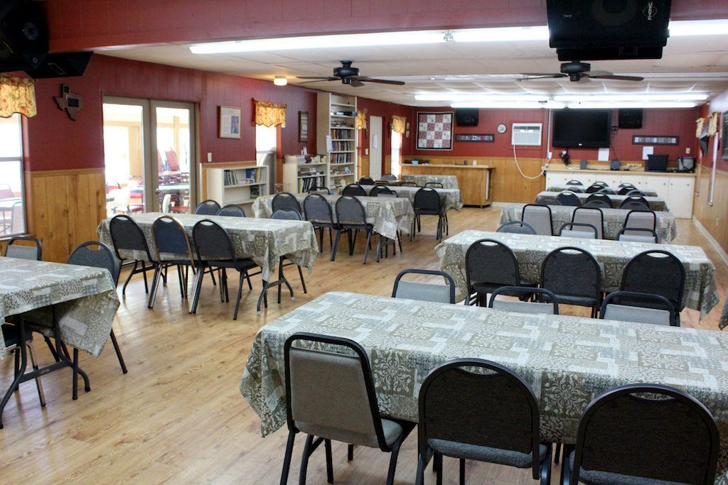 A large room with tables and chairs in it