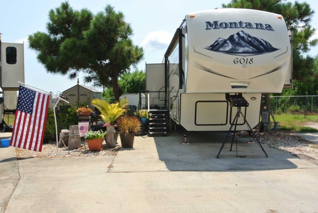 A montana trailer is parked in a driveway