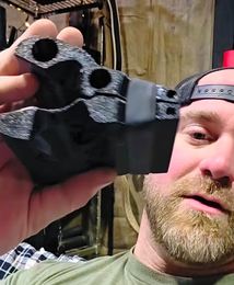Man holding black grip strength tool