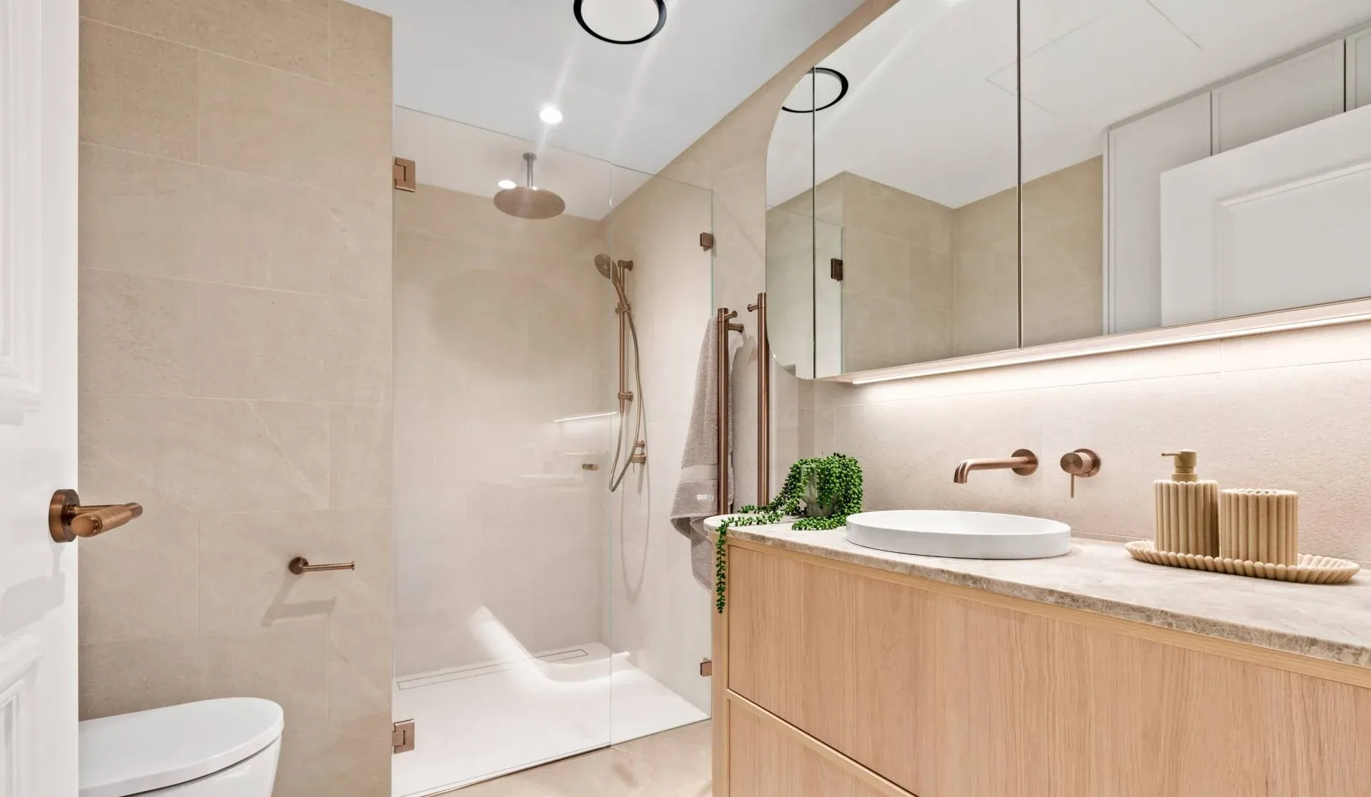 Modern Bathroom With Beige Tiles, a Glass Shower, and a Wooden Vanity — ATH Projects in Kirrawee, NSW