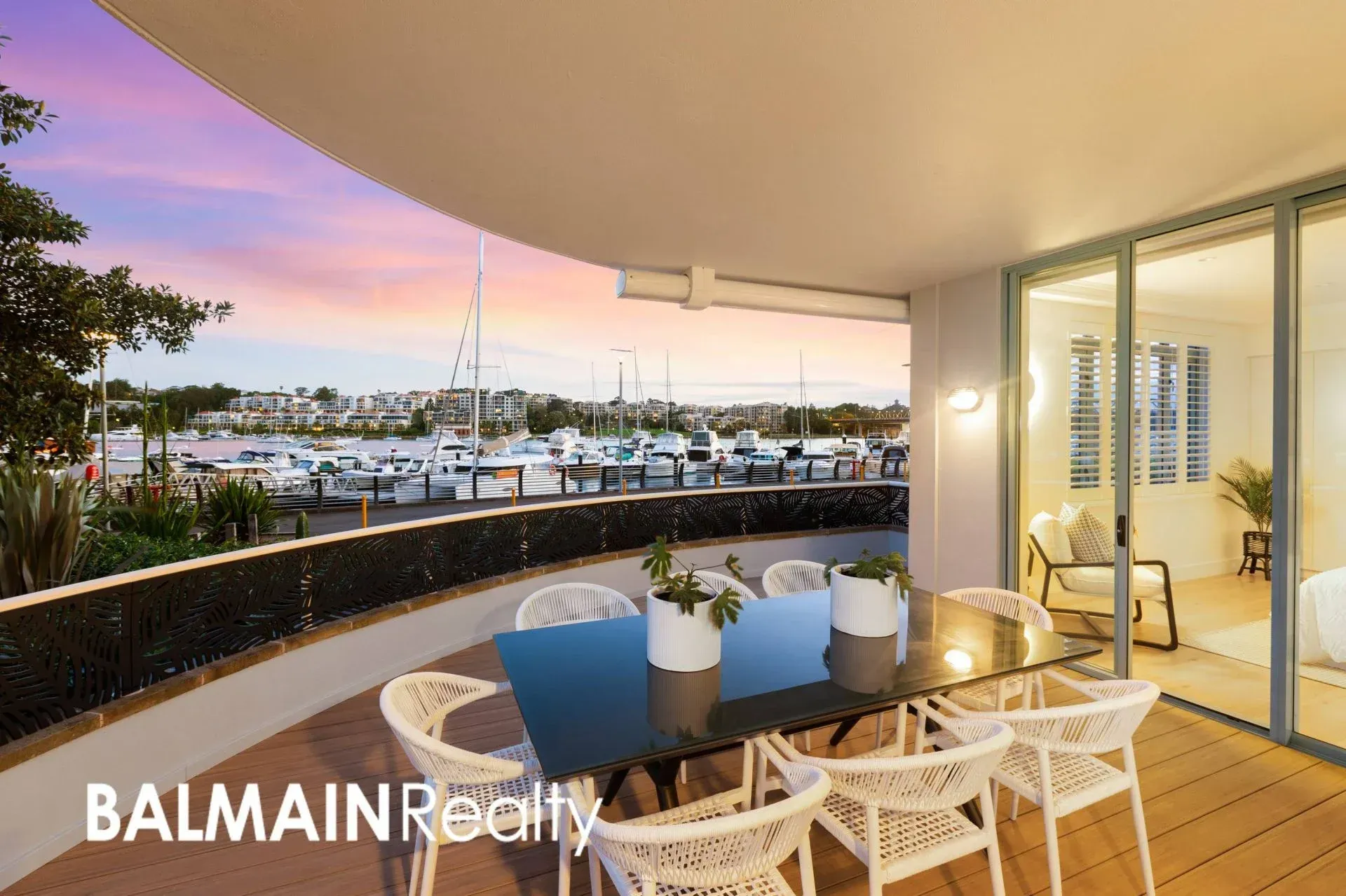 Balcony With Table and Chairs Overlooking a Marina at Sunset — ATH Projects in Drummoyne, NSW