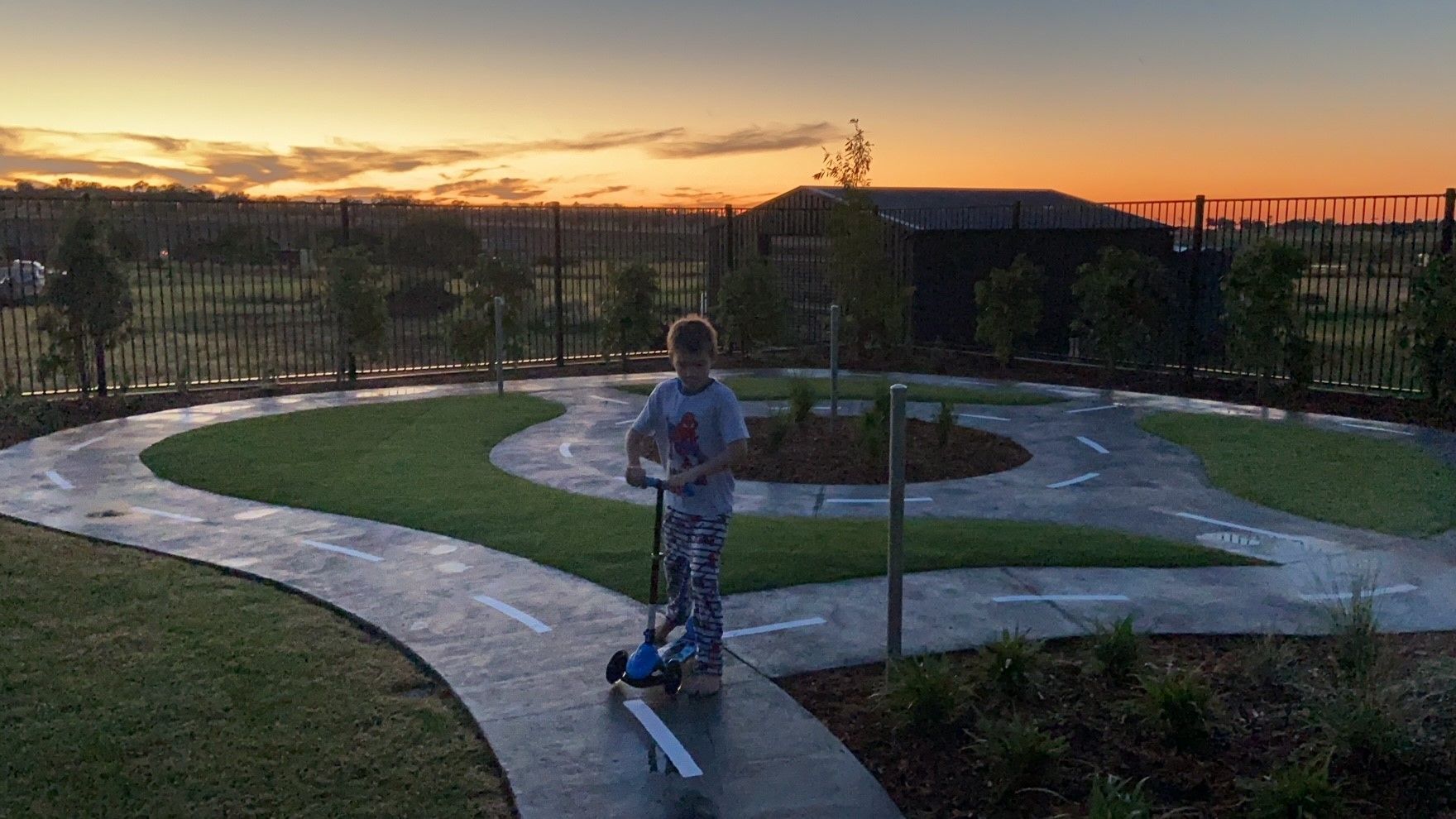 Boy on Scooter at Sunset on a Paved Track — ATH Projects in Moore Creek, NSW