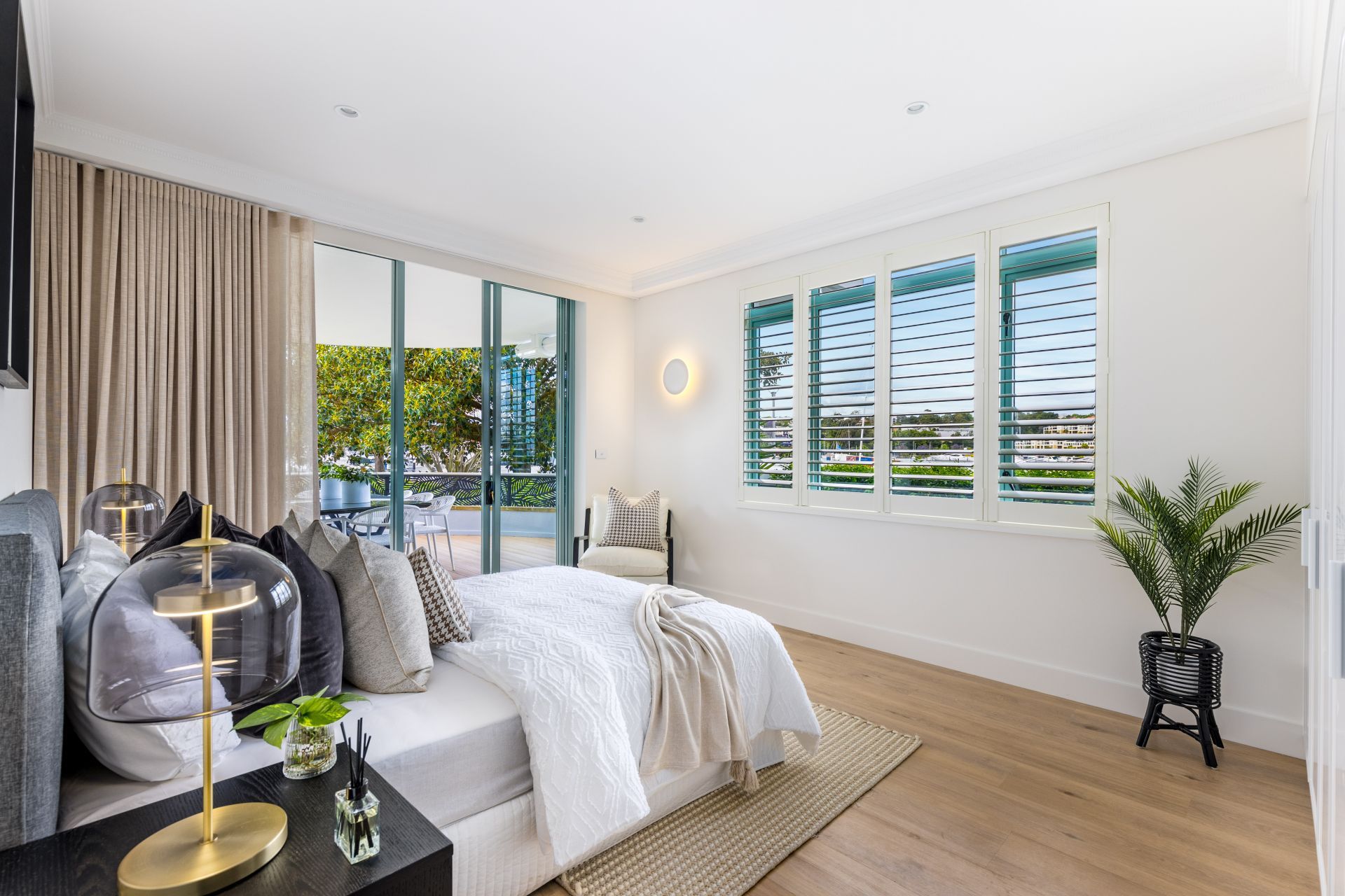 Bedroom With Bed, Rug, Shutters, and Outdoor Balcony View — ATH Projects in Drummoyne, NSW
