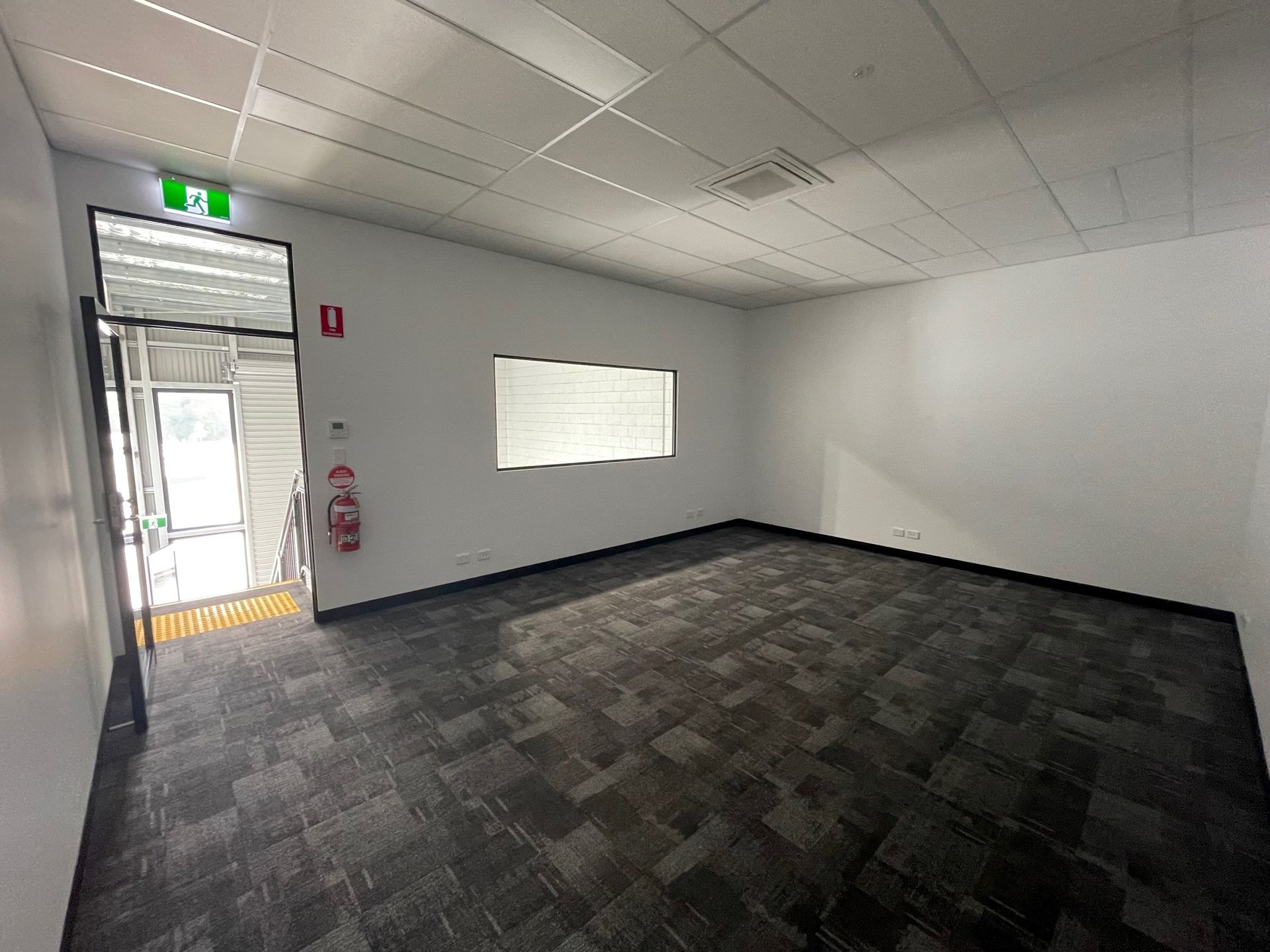 Empty Office Interior With Dark Carpet — ATH Projects in Kirrawee, NSW