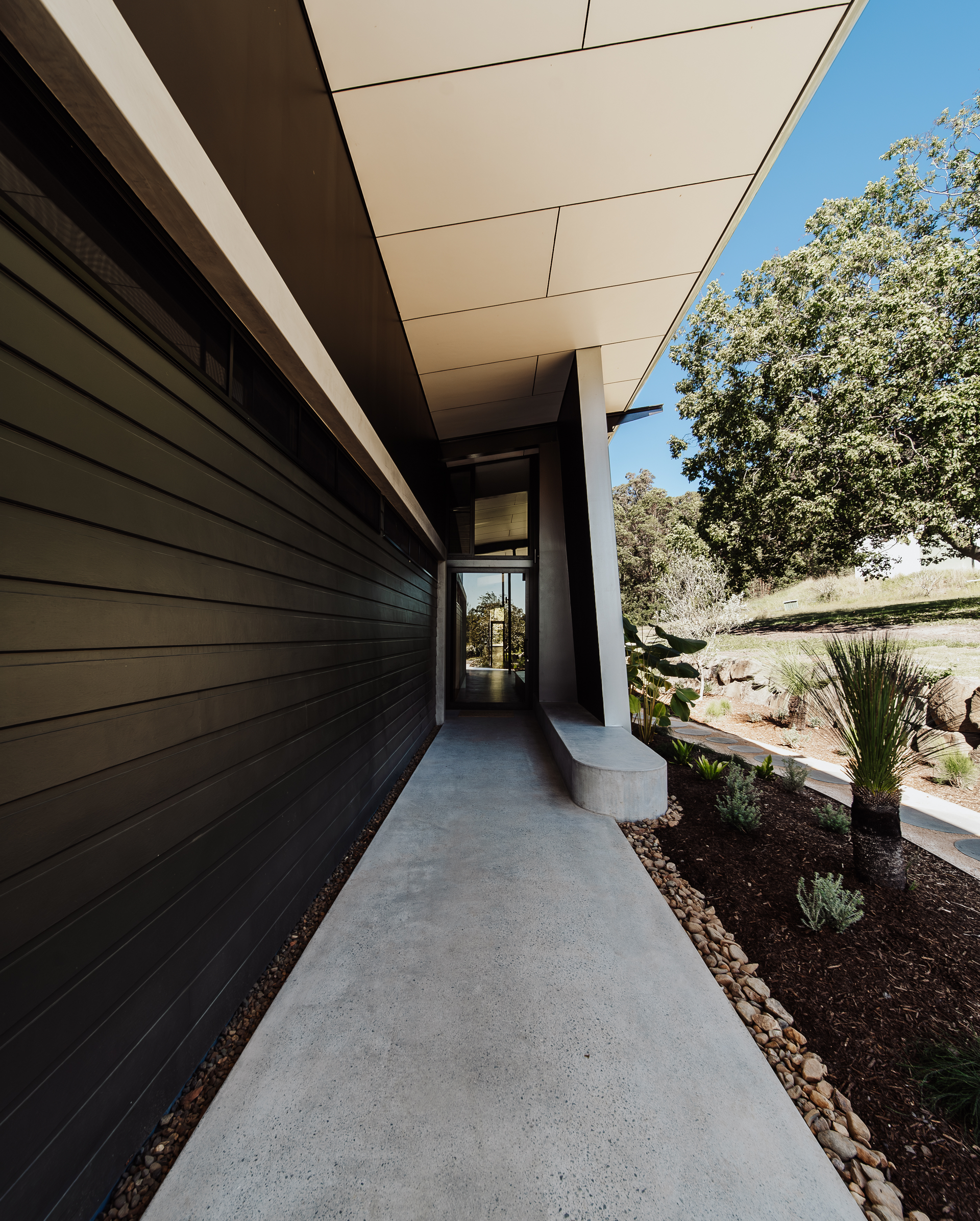 A Concrete Walkway Leads to a Glass Door — ATH Projects in Eerwah Vale, QLD