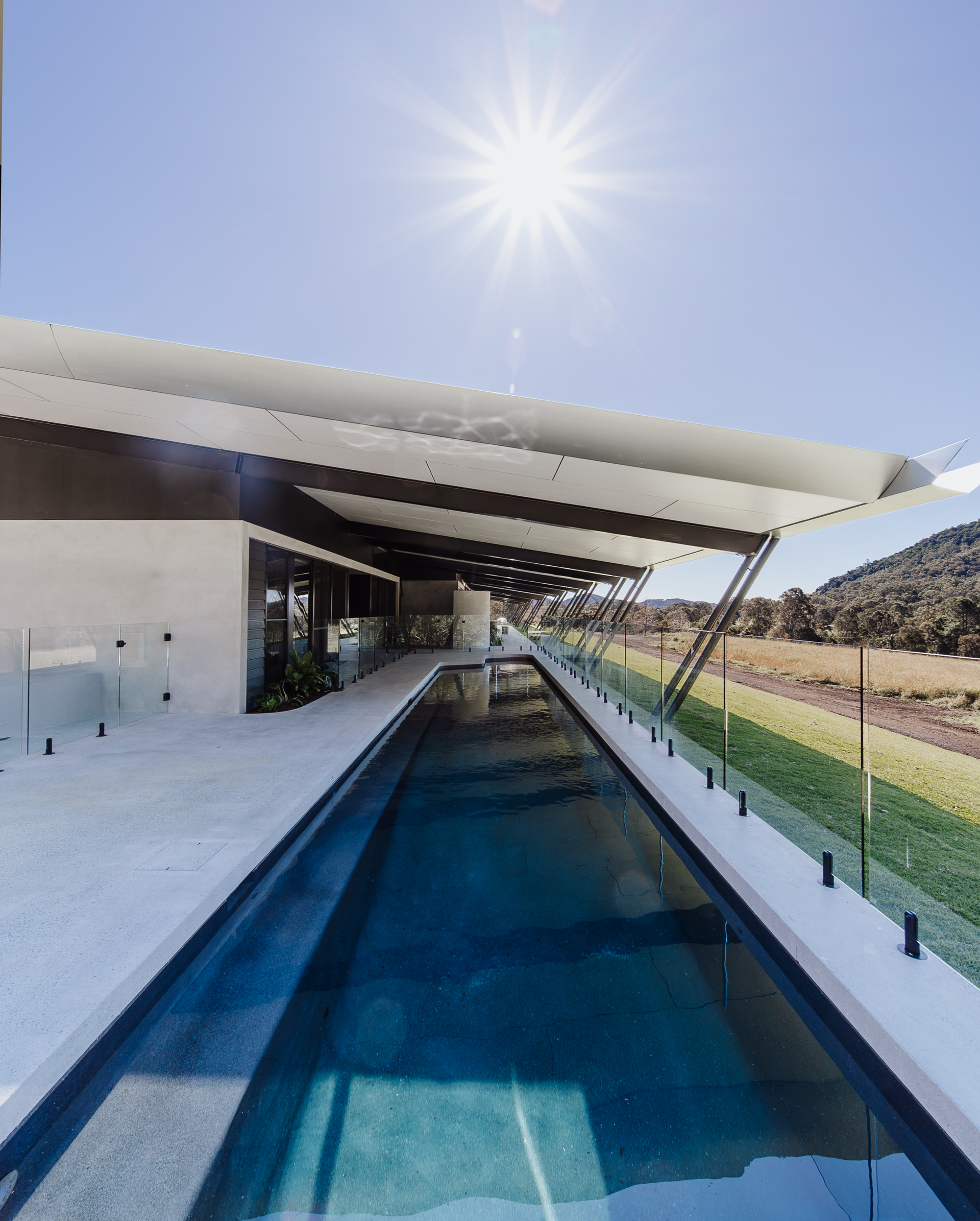 Modern Home With Long Pool, Glass Railing, and Large Roof — ATH Projects in Eerwah Vale, QLD