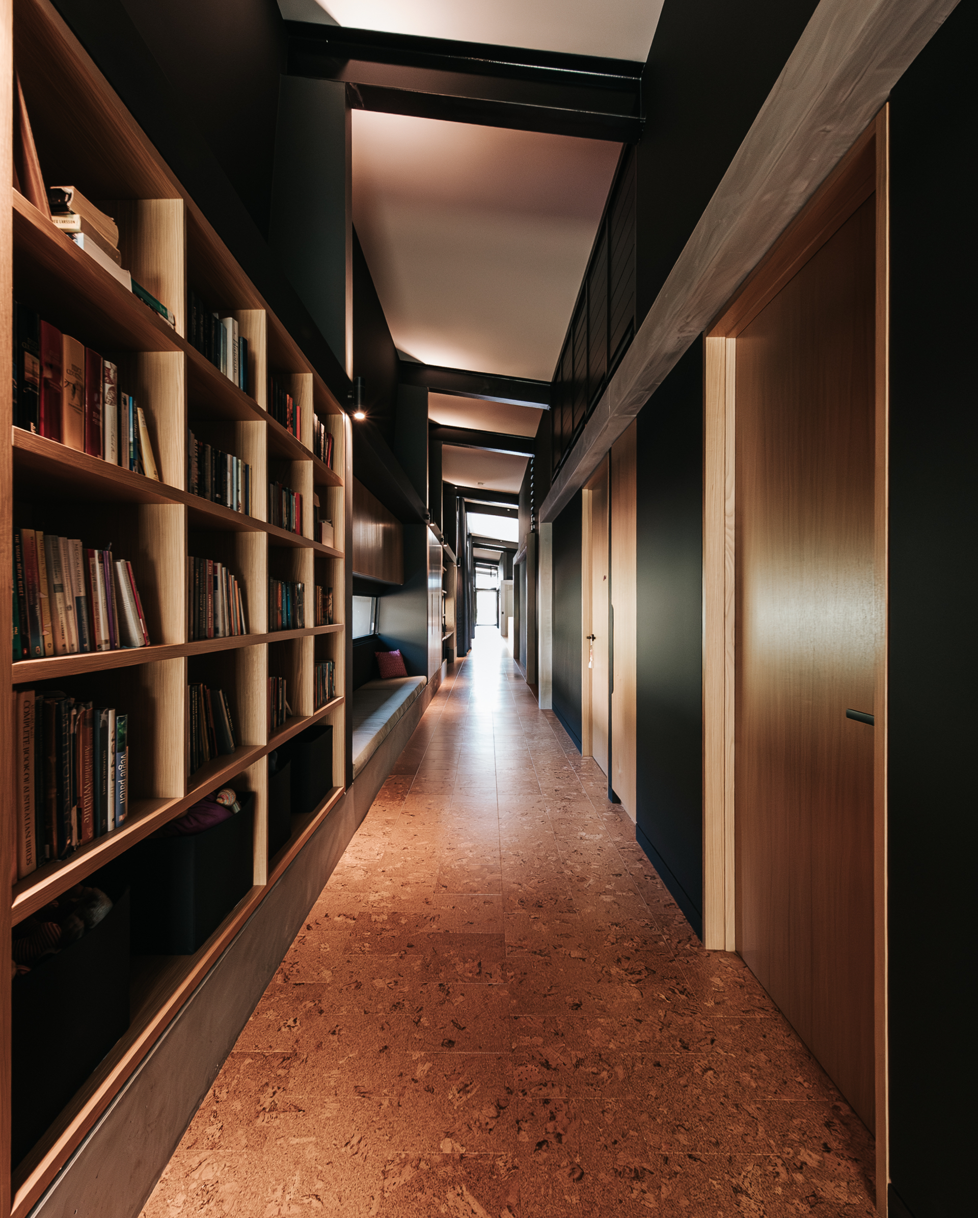 Long, Dark Hallway With Bookshelf on the Left — ATH Projects in Eerwah Vale, QLD