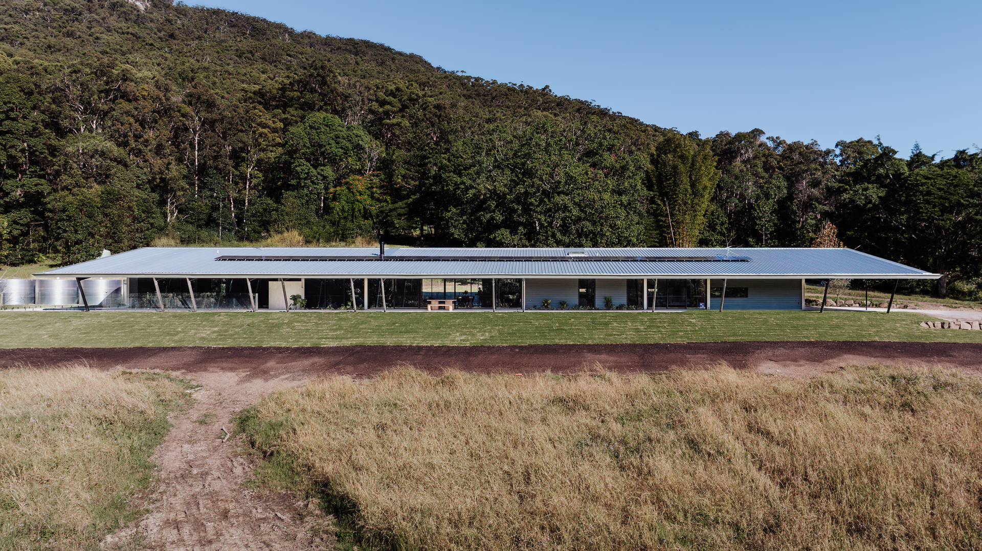 Long, Modern Home With Solar Panels on a Hillside — ATH Projects in Eerwah Vale, QLD