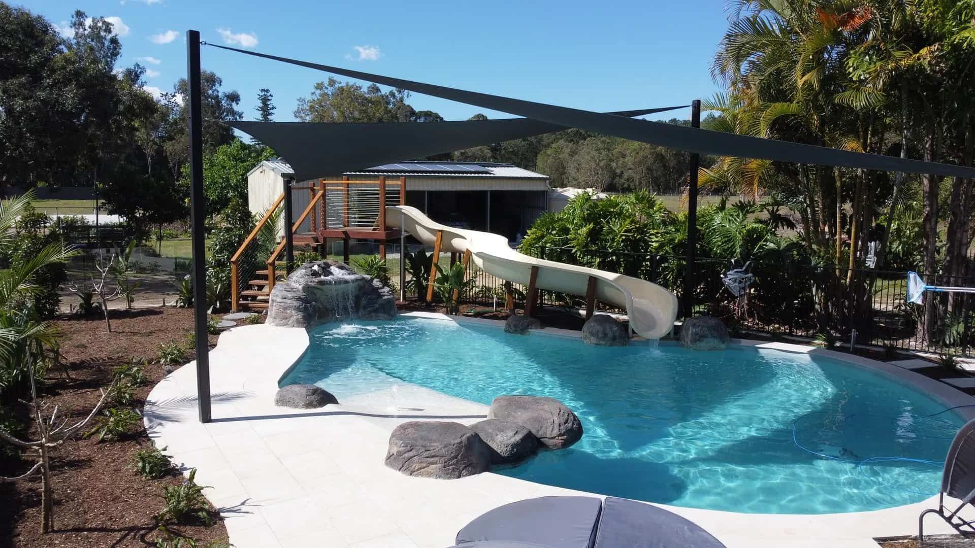 Swimming Pool With Waterslide and Shade Sails — ATH Projects in Kirrawee, NSW