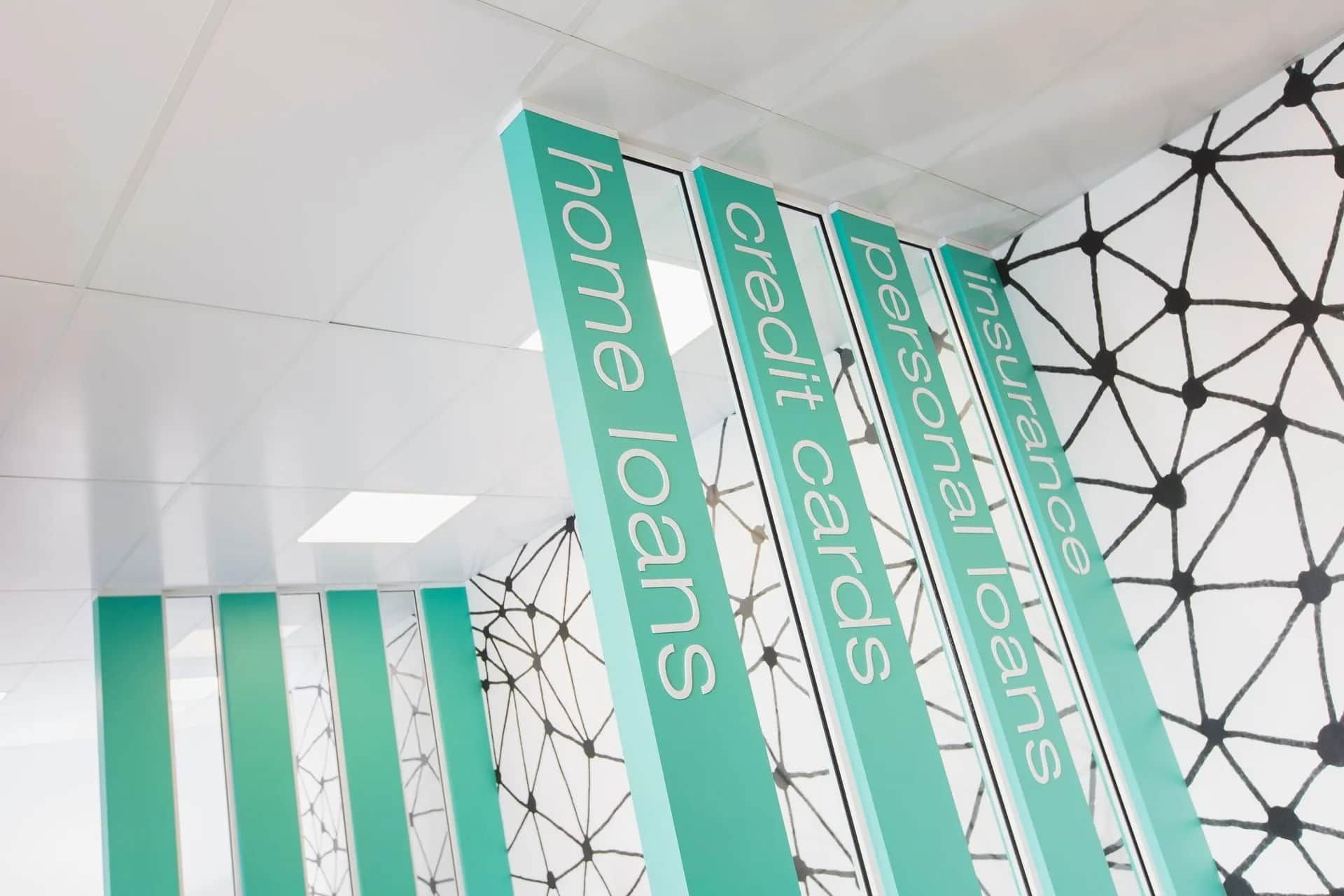 Green Signs With Text Listing Financial Services in Front of a Patterned Wall — ATH Projects in Kirrawee, NSW