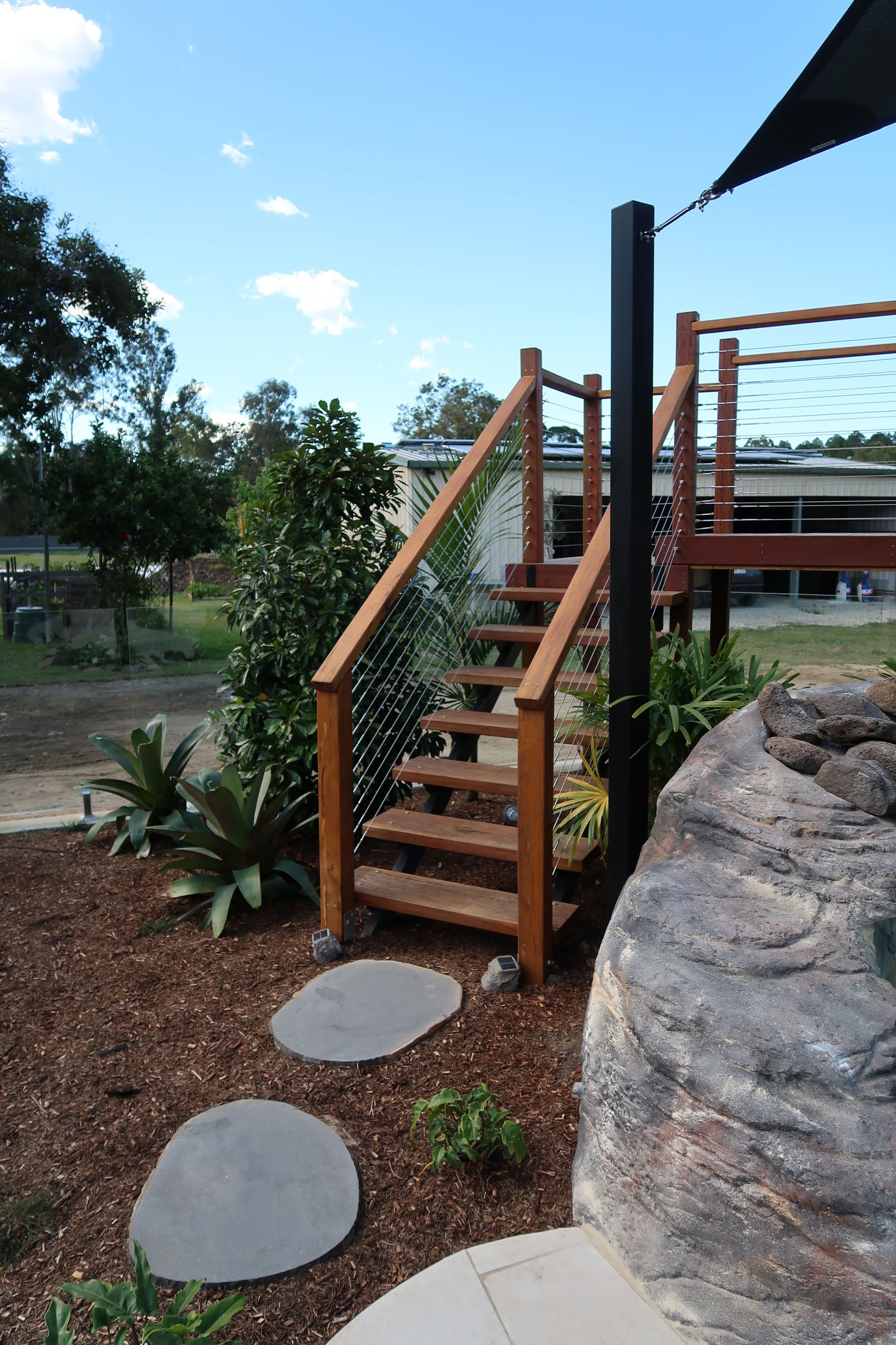 Wooden Stairs With Metal Cable Railing Lead Up to a Deck — ATH Projects in Bellmere, QLD