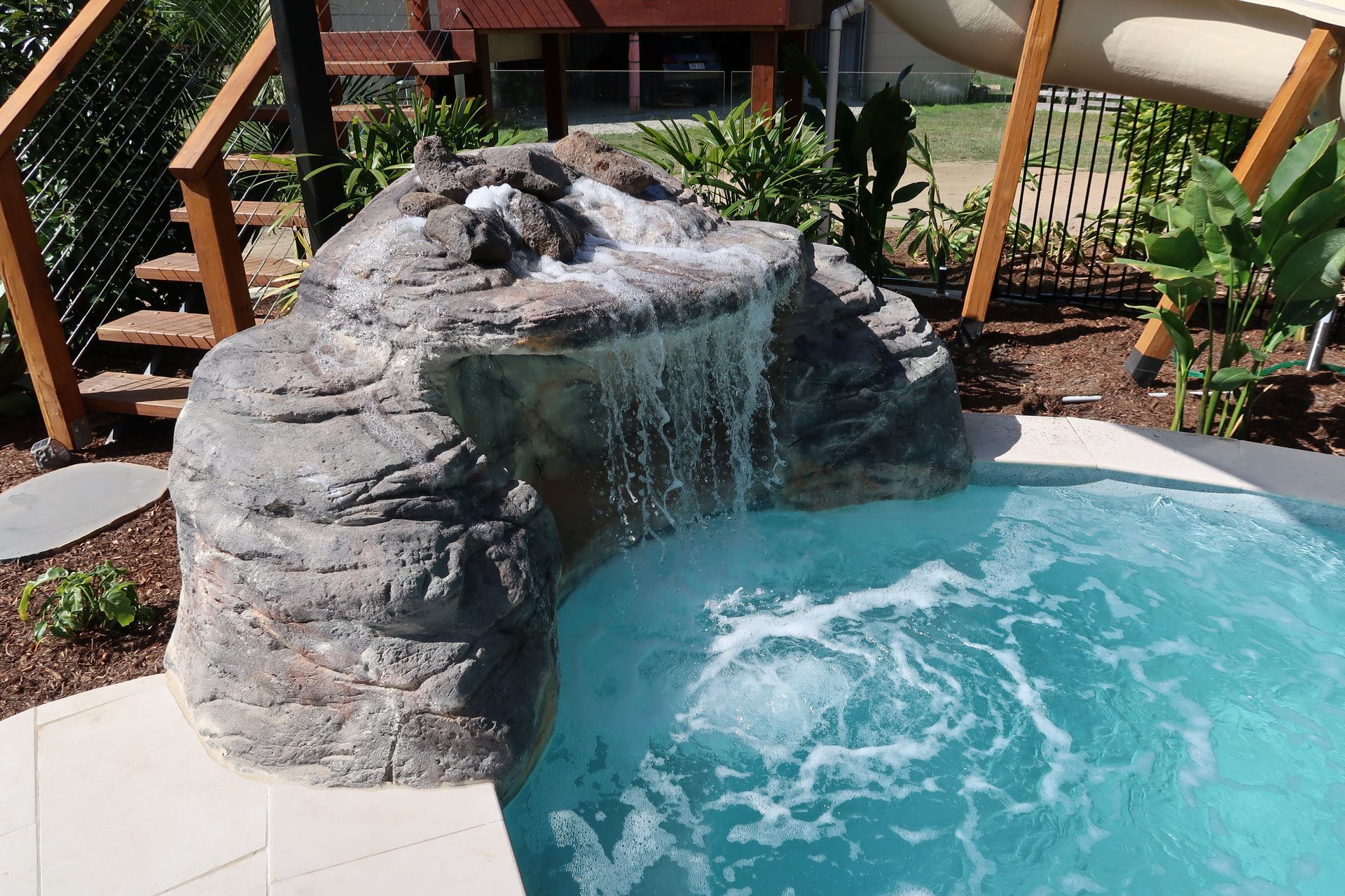 A Small Pool With a Rocky Waterfall Feature — ATH Projects in Bellmere, QLD