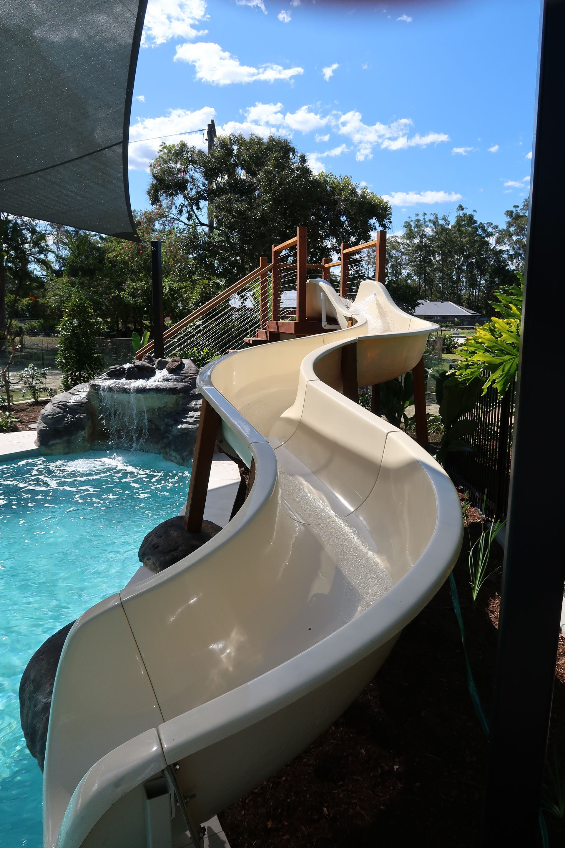 Pool Slide With Water Flowing Into a Swimming Pool — ATH Projects in Bellmere, QLD