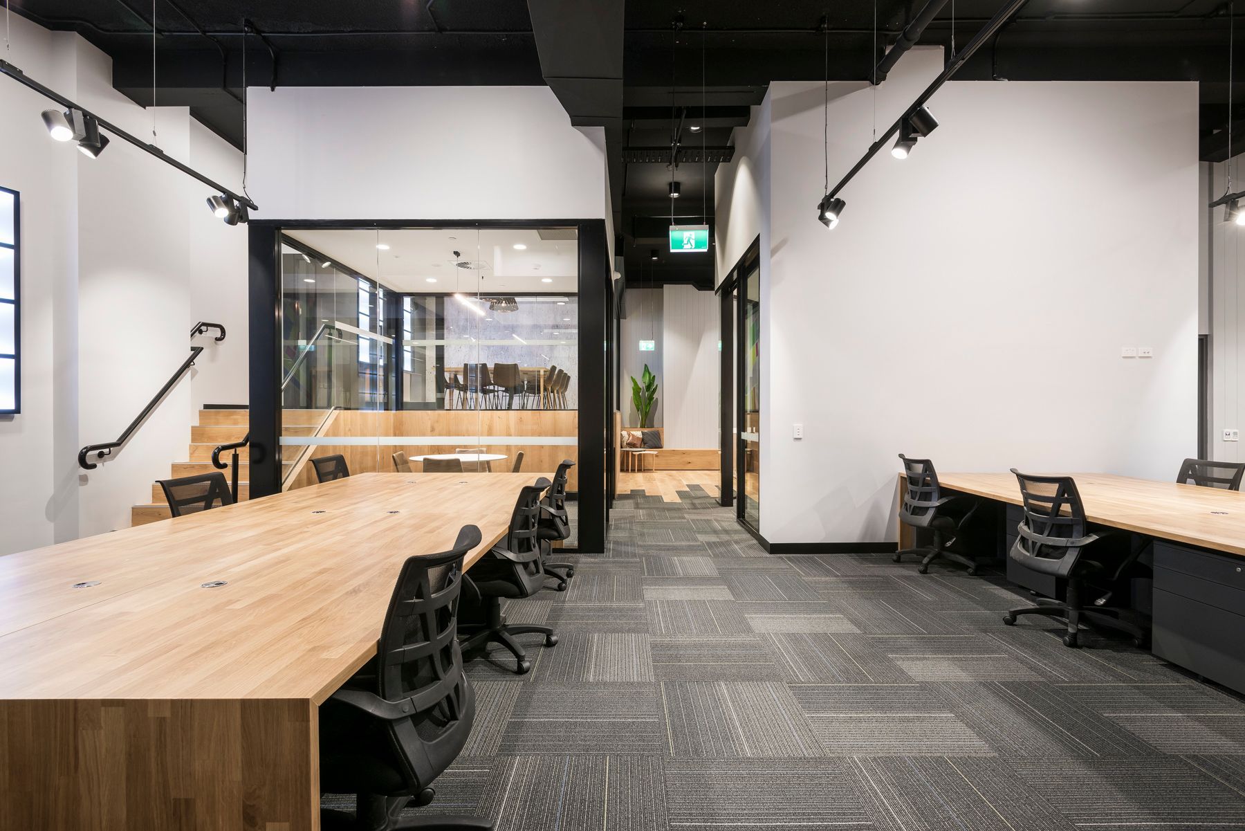 Office With Long Wooden Desks, Black Chairs, and Carpeted Floor — ATH Projects in Kirrawee, NSW