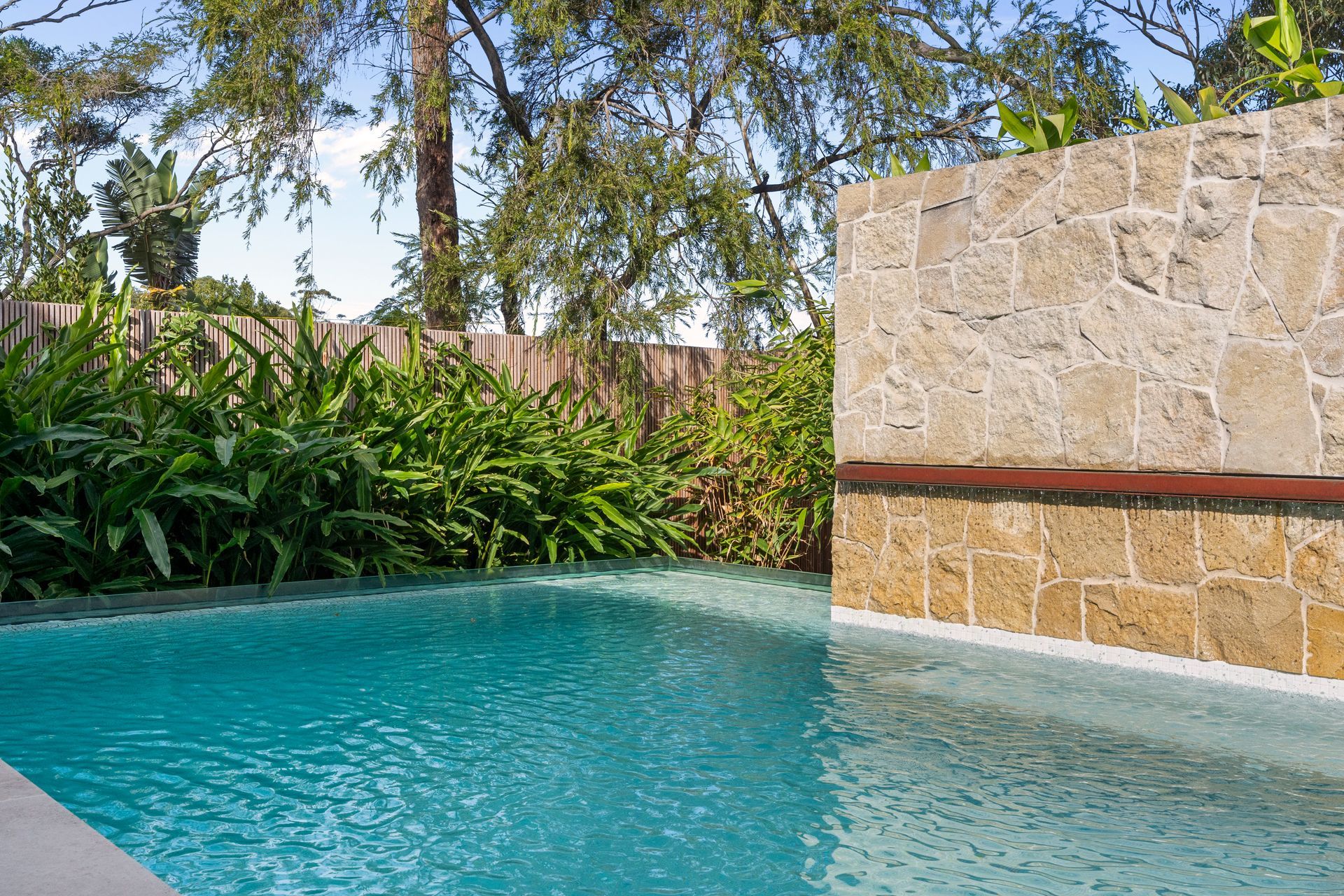 A Small Turquoise Pool With a Stone Wall — ATH Projects in Yowie Bay, NSW