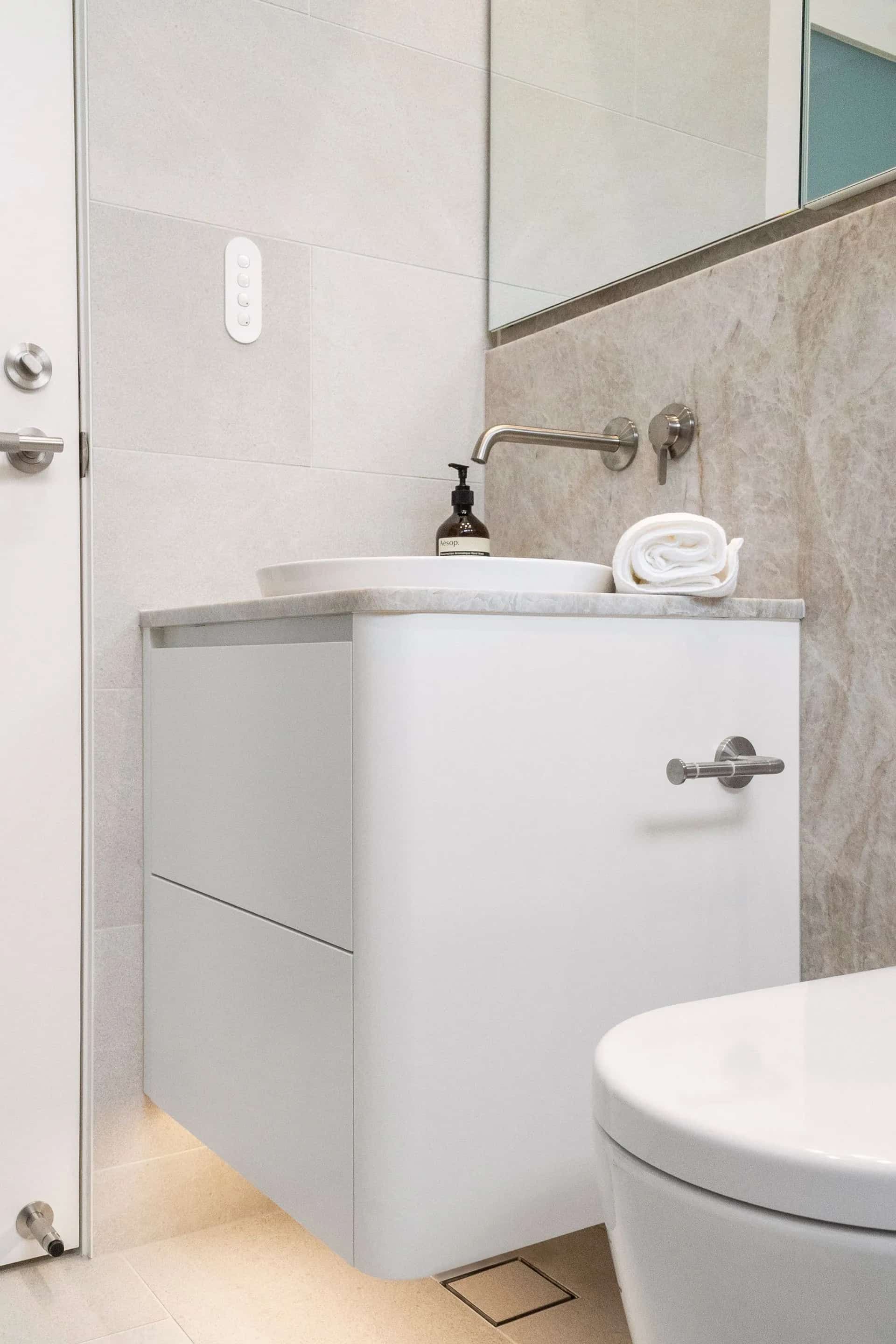 White Floating Bathroom Vanity With Sink and Faucet, Marble Wall, Toilet Visible — ATH Projects in Kirrawee, NSW