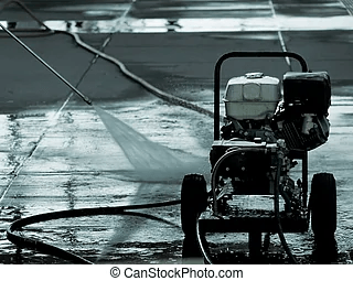 A black and white photo of a high pressure washer cleaning a tiled floor.