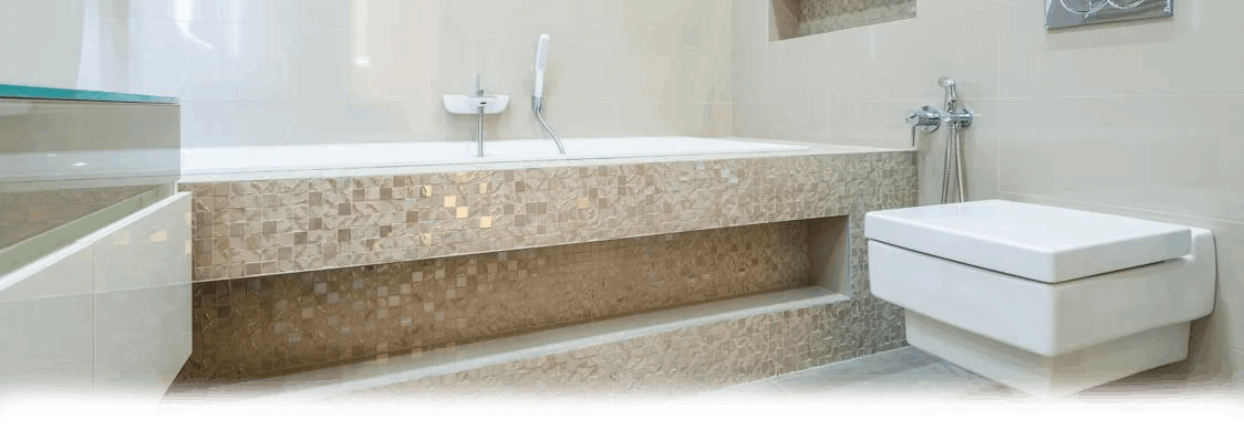 A modern bathroom with a built-in bathtub and a wall-mounted toilet; light beige color palette.