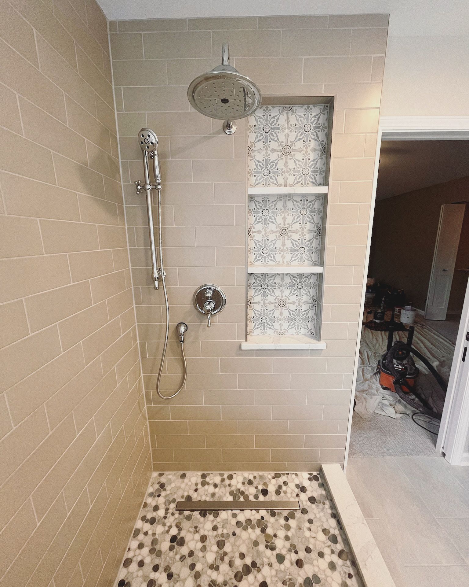 A & R Home Services remodel  bathroom with a walk in shower and a shower head.