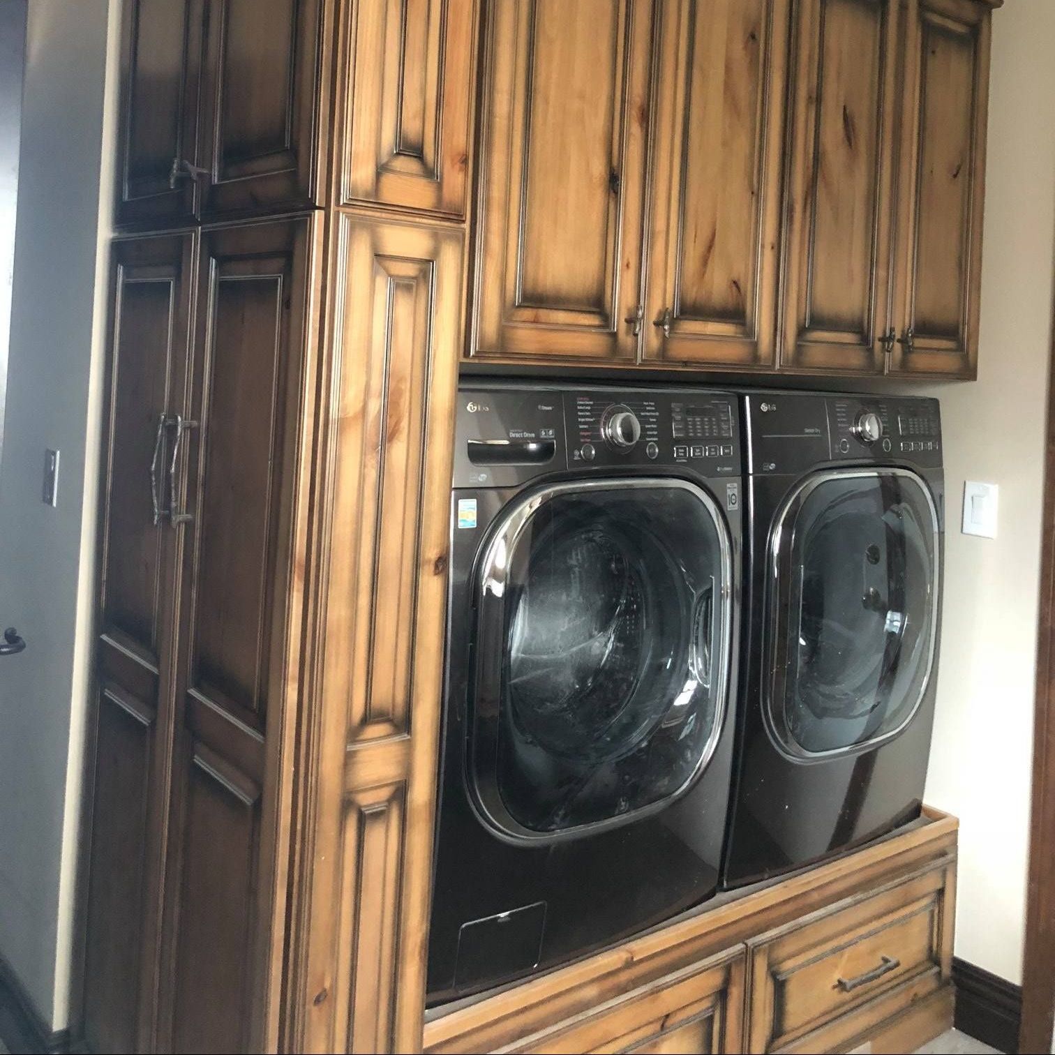 A & R Home Services remodel  washer and dryer in a laundry room with wooden cabinets
