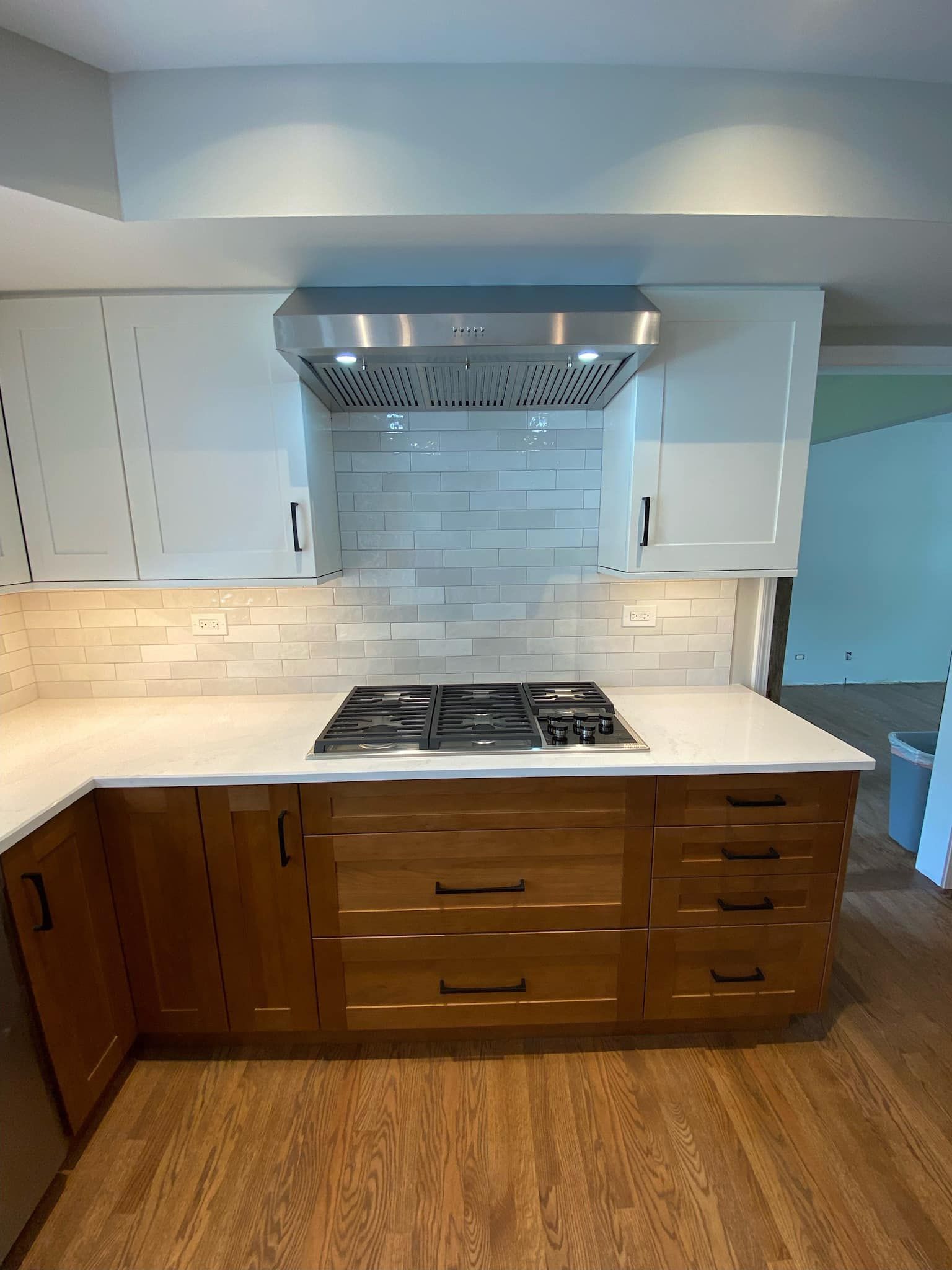 A & R Home Services  kitchen with wooden cabinets and a stove top oven.