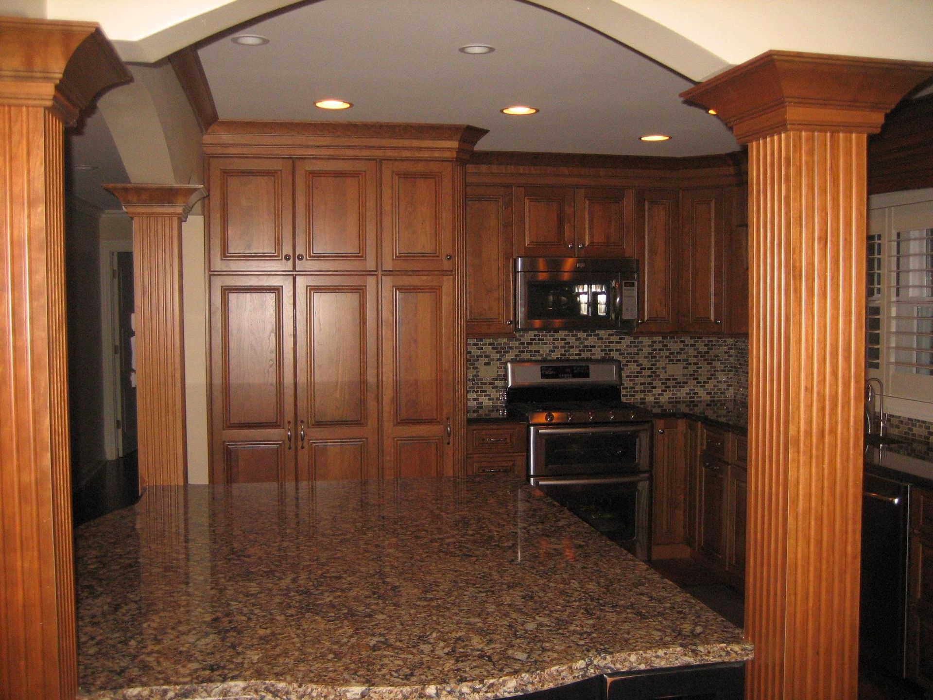 A & R Home Services  kitchen with wooden cabinets and granite counter tops