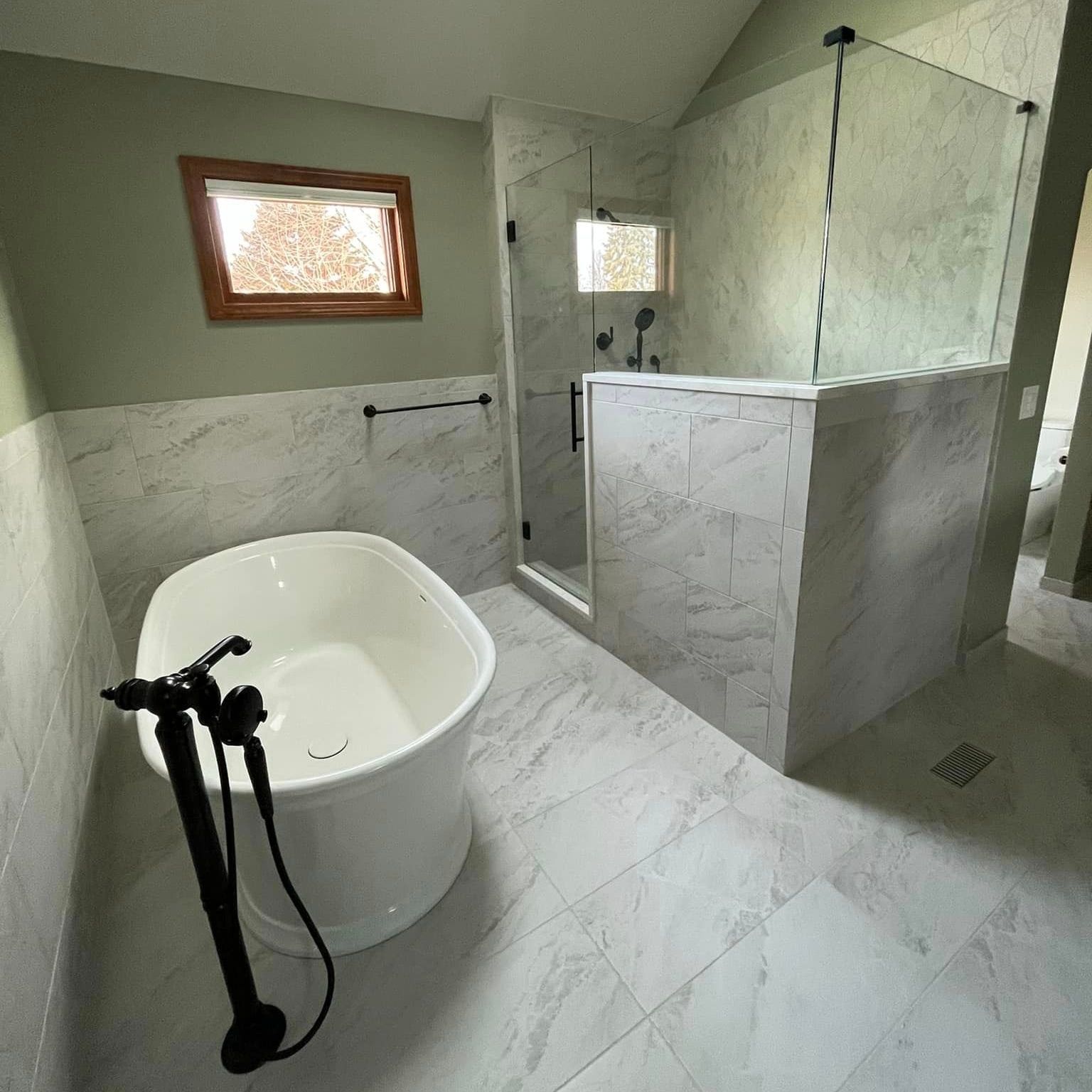 A & R Home Services remodel  bathroom with a bathtub and a walk in shower.