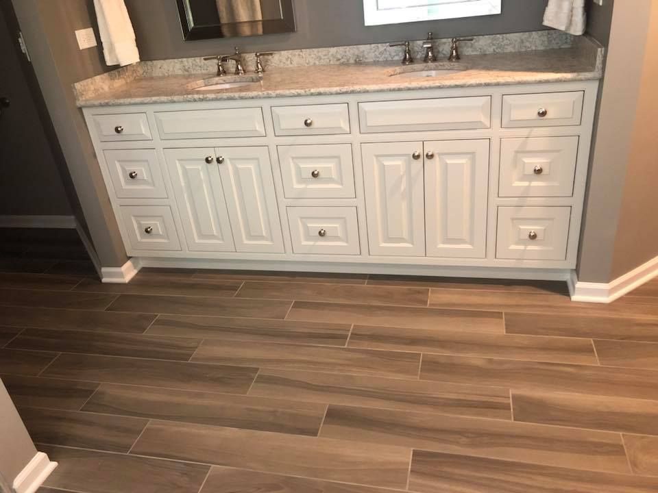 A & R Home Services  bathroom with two sinks and a tiled floor.