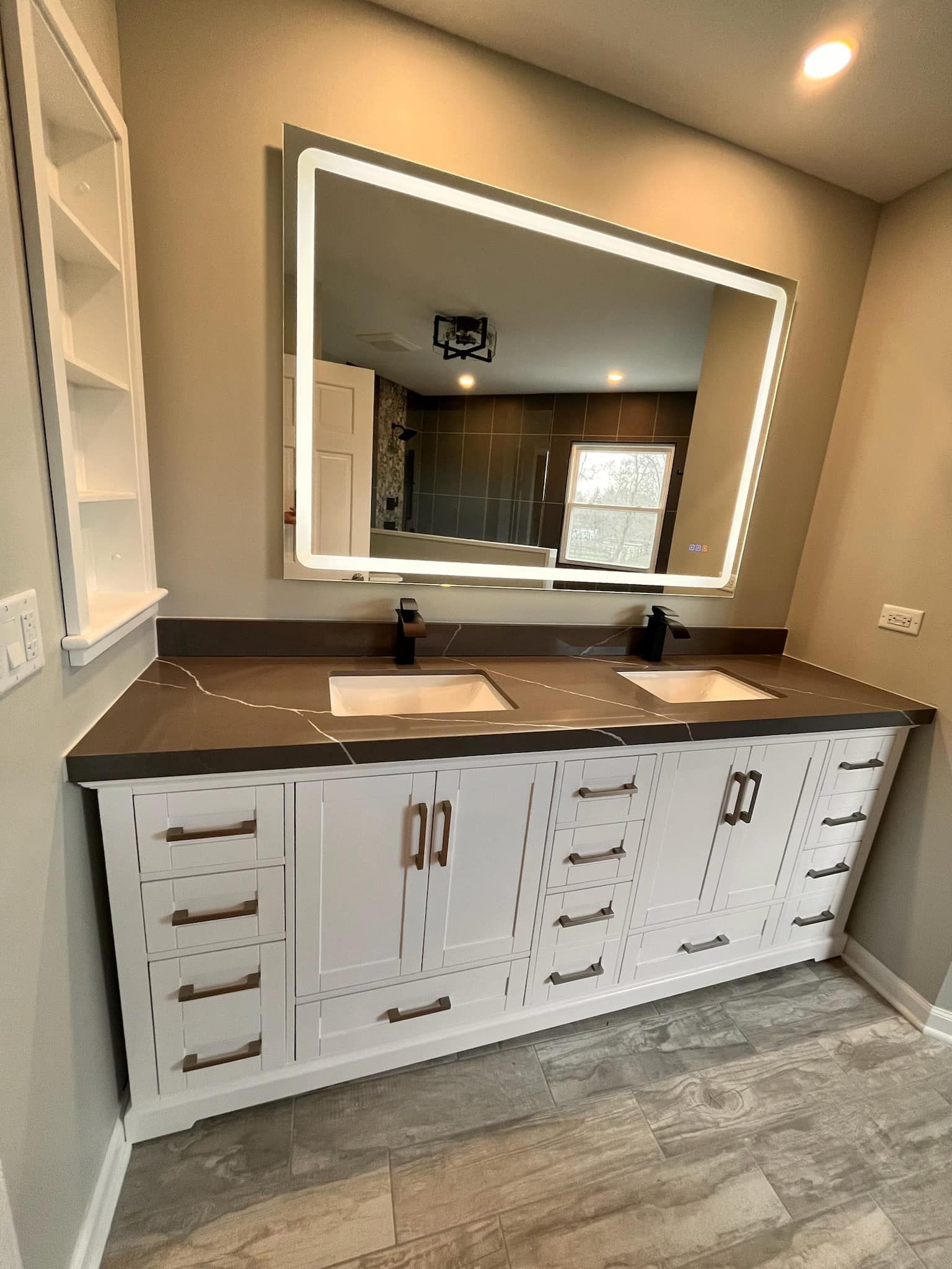 A & R Home Services remodel  bathroom with two sinks and a large mirror.